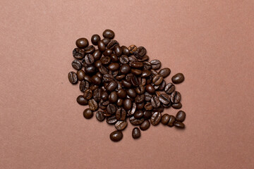 Poster - coffee beans in a brown background