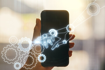 Aufkleber - Double exposure of robotics technology hologram and hand with cell phone on background. Research and development software concept