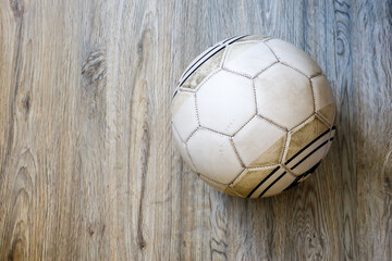 old soccer ball on wood background