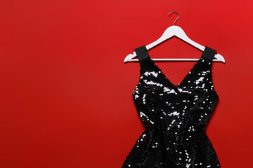 Wall Mural - Beautiful dress and hangers on red background, flat lay. Rental clothing service