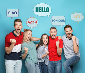 Canvas Print - Happy people and illustration of speech bubbles with word Hello written in different languages on light blue background