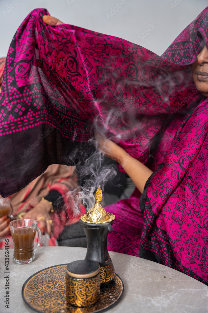 Black Muslim woman putting on incense Stock Photo | Adobe Stock