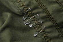 Top View Of Metal Safety Pins On Clothing