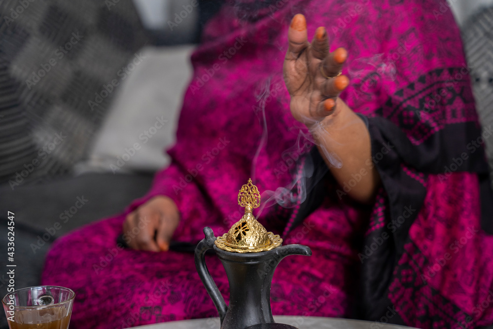 Black Muslim woman putting on incense Stock Photo | Adobe Stock