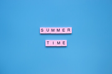 Wall Mural - Summer time word on a blue background.