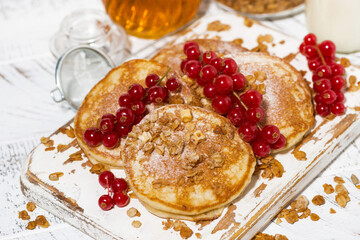 Wall Mural - delicious pancakes with berries and honey on a white wooden board