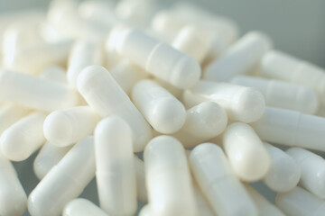 Wall Mural - White medical pills on glass table. Close up