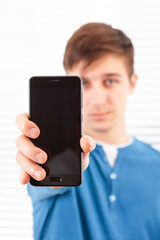 Canvas Print - Young Man show a Phone