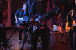 © Wavebreak Media - Midsection of diverse music band with guitarists and keyboard player during concert in music venue