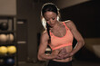 © Wavebreak Media - Athletic mixed race woman flexing her biceps, exercising in gym