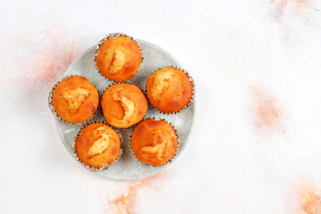 Homemade delicious orange muffins with fresh oranges.