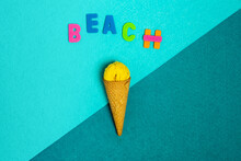 Overhead View Of Beach Title Over Crunchy Waffle Cone With Woolen Thread Ball On Two Color Background