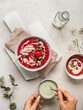 © Cintia Viudez/ADDICTIVE STOCK - Top view of crop unrecognizable person stirring matcha tea in cup placed on table with sweet cold berry soup with popsicle in bowl