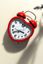 Red Metal Alarm Clock In Shape Of Heart Placed On Vibrant Beige Background In Studio