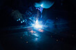 © Ekaitz Gerique/ADDICTIVE STOCK - Crop faceless worker in gloves and uniform welding metal details on table near constructions in factory