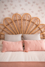 Comfortable Cute Natural Vintage Rattan Headboard Bed With Ornamental Cushions In A Room