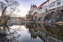 Historic Stone Building Of Cesky Krumlov Castle And Calm River Under Sundown Sky