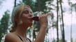 Young woman drinking wine outdoors. Girl enjoying bbq party on backyard