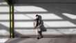 © Picua Estudio/ADDICTIVE STOCK - Stylish male leaning on gray shabby wall in urban area of city illuminated by sunlight and looking away