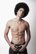 © Shey Nunez/ADDICTIVE STOCK - Young confident black man with six pack abs and Afro hairstyle looking at camera on white background