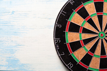 target dart board on the blue table, center point, head to target marketing and business success concept