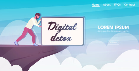 man pushing tablet with digital detox text into abyss guy abandoning gadgets internet and social networks