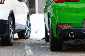 Wall Mural - close-up of a green and white car parked on the side of the street