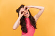 © Anastasia - Studio portrait of a cheerful emotional girl on a bright yellow background.