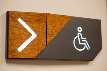 Wall Mural - Closeup of PWD comfort room signage with an arrow sign showing the direction