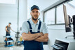 © Drazen - Portrait of smiling confident mechanic at car workshop looking at camera.