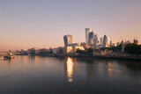 Fototapeta  - View of riverbank Thames River against skyscrapers. Urban skyline of London at morning light , United Kingdom..