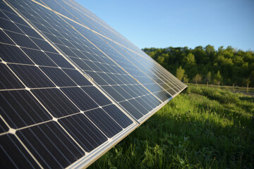 Wall Mural - Solar panel against blue sky background. Photovoltaic, alternative electricity source. Idea for sustainable resources.Alternative power energy concept.Solar Farm on green grass