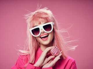 Wall Mural - cheerful woman glamor fashion glasses pink background sweets