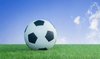 Wall Mural - football on grass on blue sky background