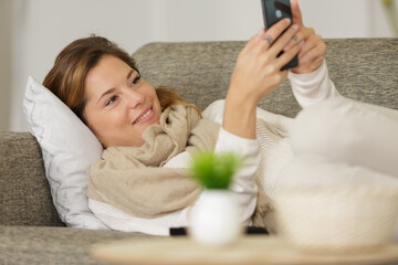 cheerful young woman using her mobile phone