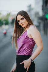 Wall Mural - Gorgeous Caucasian female in stylish purple and black outfit posing in the street