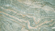 The texture of the stone is green with orange streaks. Background