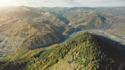 Wall Mural - Sun over mountain ranges aerial. Pine forest at mount hills. Town at river shore. Village with fields at isolated lands. Green grass valley. Cottages at Peneda Geres National Park, Portugal, Europe