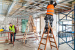 © bulentbaris - Plasterer man at work with trowel plastering the wall of interior construction site