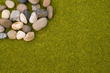 Sticker - Closeup shot of cobbles on the green grass background