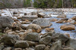 Stream of the mountain river Pemigewasset among stones hewn by an ancient glacier