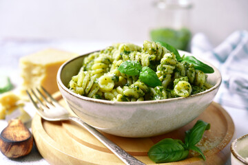 Wall Mural - Fusilli pasta with pesto sauce - traditional dish of italian cuisine.