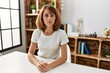 © Krakenimages.com - Young caucasian girl wearing casual clothes sitting on the table at home relaxed with serious expression on face. simple and natural looking at the camera.