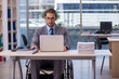 © Elnur - Young male employee in wheel-chair working in the office