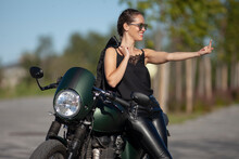 Portrait Of Young Woman On A Black Motorcycle