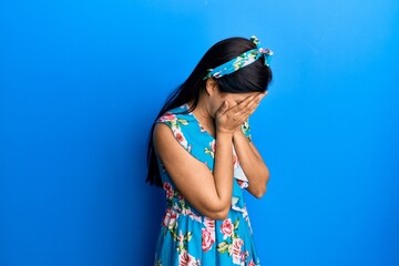 Sticker - Young latin woman wearing casual clothes with sad expression covering face with hands while crying. depression concept.