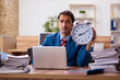 © Elnur - Young male employee in time management concept