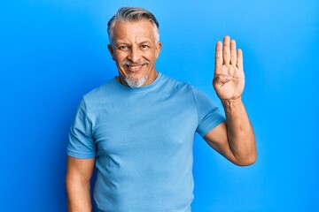 Canvas Print - Middle age grey-haired man wearing casual clothes showing and pointing up with fingers number four while smiling confident and happy.