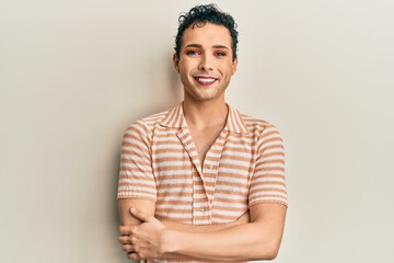 Handsome man wearing make up wearing casual t shirt happy face smiling with crossed arms looking at the camera. positive person.