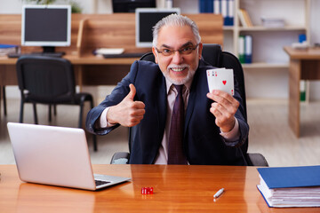 Sticker - Old male employee playing cards at workplace